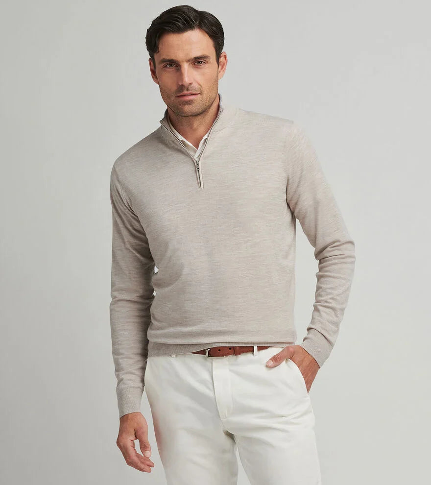 Man wearing light gray Peter Millar quarter-zip sweater with white pants