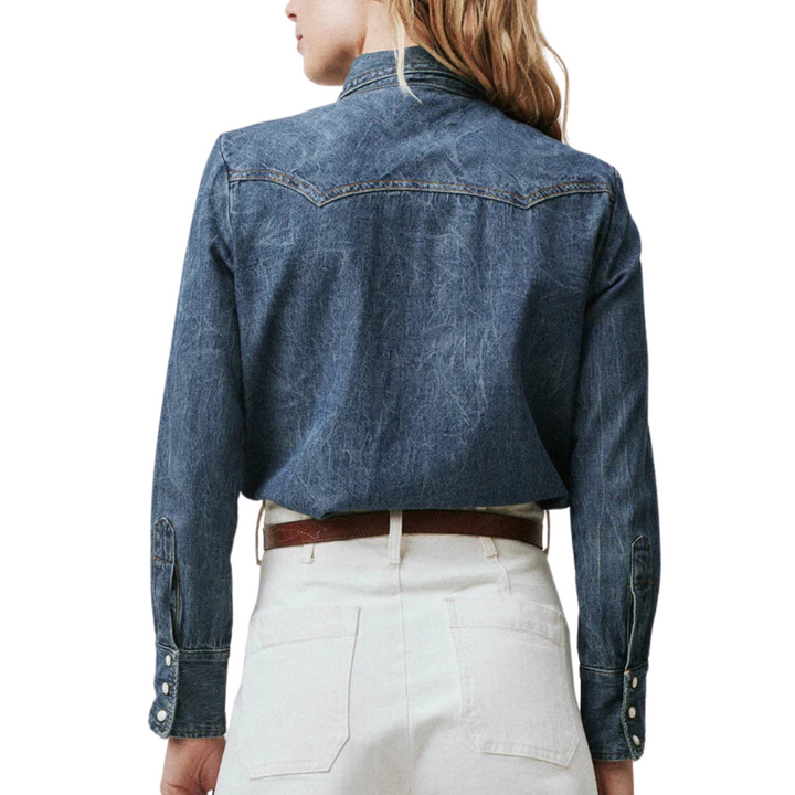 The Great Howdy Top denim western shirt back view on model with white pants