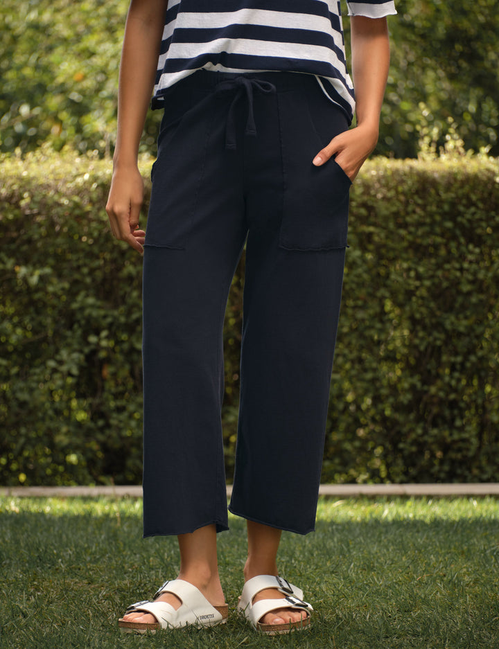 Navy wide-leg cropped pants with drawstring waist and patch pockets worn with Birkenstock sandals