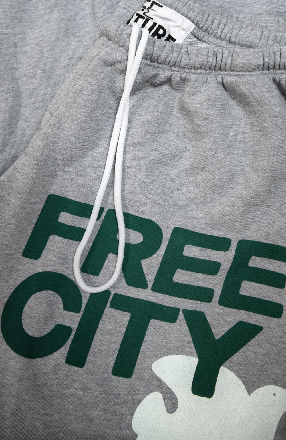 Free City grey sweatpants with green logo text and white drawstring details