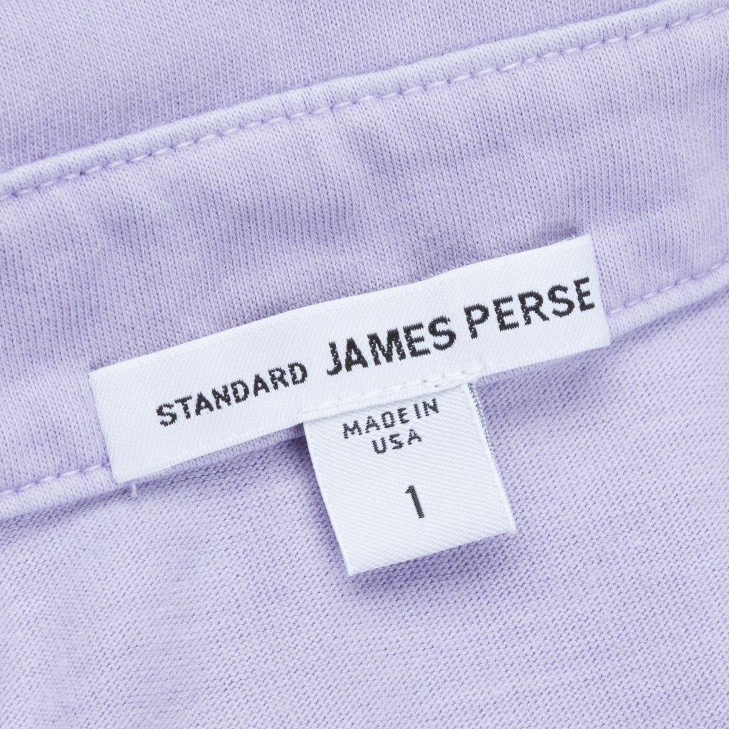 Close-up of Standard James Perse clothing label on lavender fabric showing size 1