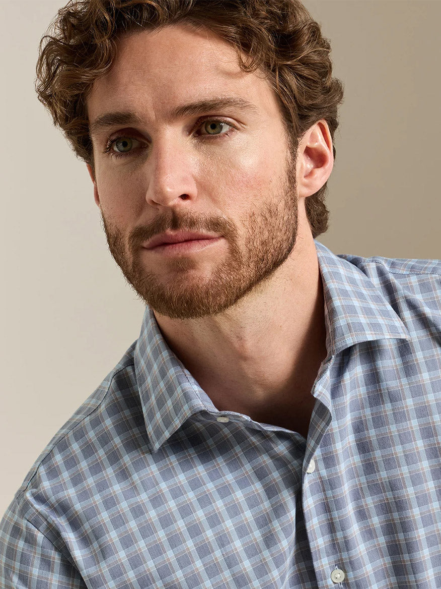 Man wearing Peter Millar blue plaid cotton-stretch button-up dress shirt close-up