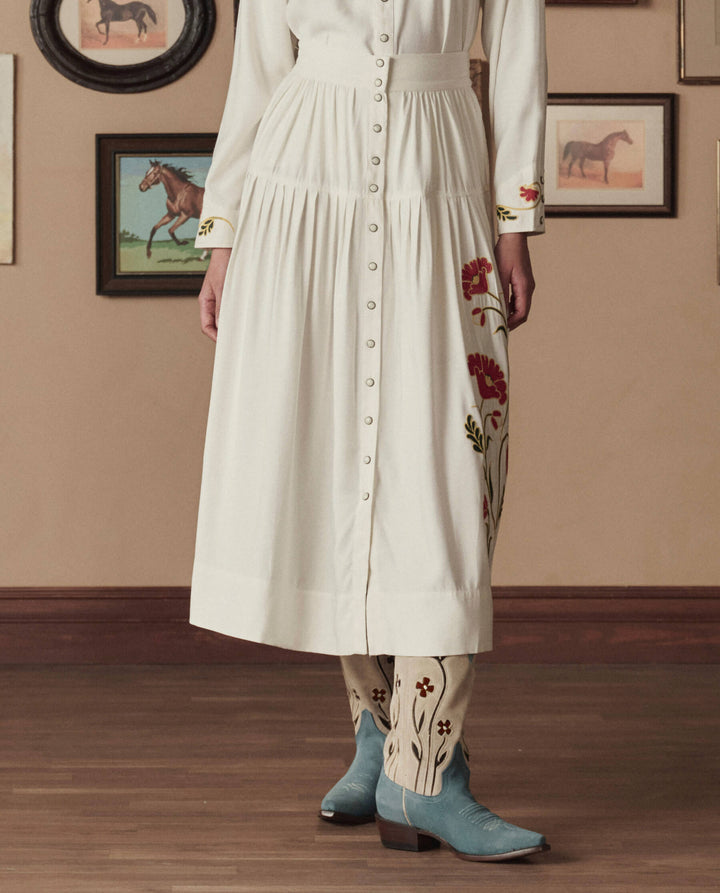 White button-front midi dress with floral embroidered sleeves and hem styling