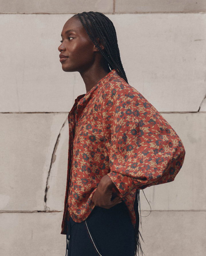 The Great Ashland Top in red floral print worn by model in profile view