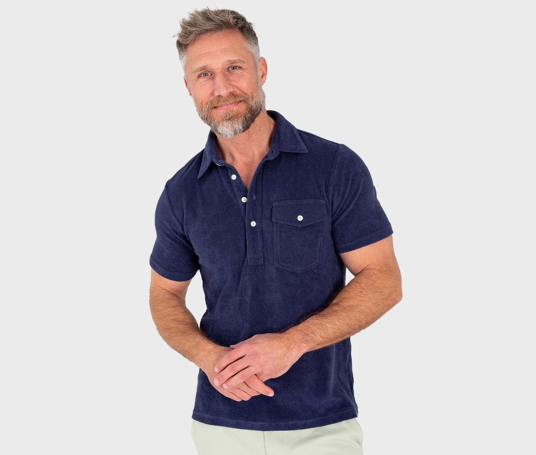 Man wearing navy blue Criquet terrycloth polo shirt with collar and chest pocket