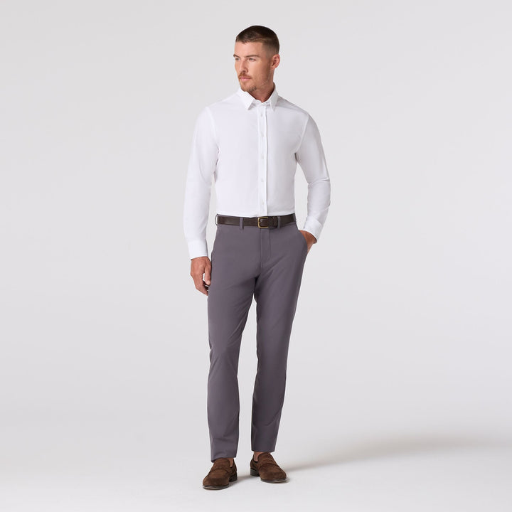 Mizzen & Main Leeward long sleeve white dress shirt on male model with gray trousers