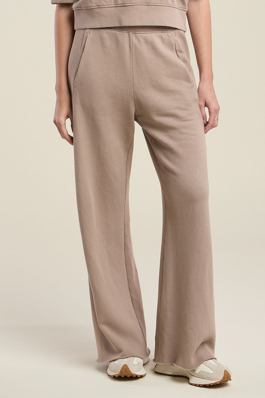 Velvet wide-leg taupe sweatpants with side pockets and raw hem detail